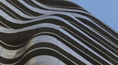 The undulating form of the aluminium-clad balconies on angle, architecture, building, daytime, facade, landmark, line, roof, sky, structure, black, teal