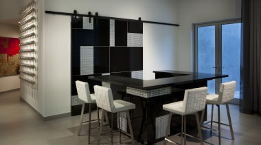 Sliding doors conceal part of this glittering bar dining room, furniture, interior design, room, table, gray, black