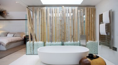The glass wall with bamboo trunks screens the bathroom, bathtub, interior design, plumbing fixture, room, gray