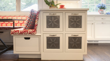 A small peninsula beside a banquette seating area cabinetry, chest of drawers, drawer, floor, flooring, furniture, hardwood, wood stain, white, brown