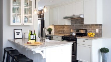 A peninsula forms the centerpiece of this remodeled cabinetry, countertop, cuisine classique, home, interior design, kitchen, room, white, gray