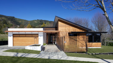 This new David Reid Homes show home in architecture, building, cottage, elevation, estate, facade, home, house, landscape, property, real estate, residential area, sky, blue