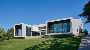 Cantilevered wings project out over the ridge on architecture, building, corporate headquarters, cottage, daytime, elevation, estate, facade, home, house, property, real estate, residential area, sky, villa, window, teal