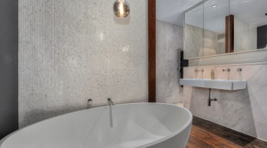 Large mirrors above the bathroom vanity conceal storage bathroom, bathroom sink, bidet, ceramic, floor, interior design, plumbing fixture, product design, room, sink, tap, tile, gray