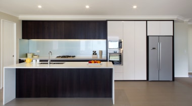 A two-tone colour palette brings a touch of architecture, cabinetry, countertop, floor, flooring, interior design, kitchen, real estate, room, gray