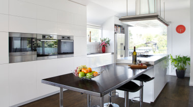 This contemporary kitchen, designed and manufactured by Mastercraft architecture, countertop, floor, flooring, house, interior design, kitchen, real estate, table, white, black