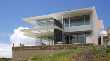 On this home, large roof overhangs made with apartment, architecture, building, condominium, elevation, facade, home, house, property, real estate, residential area, sky, villa, blue