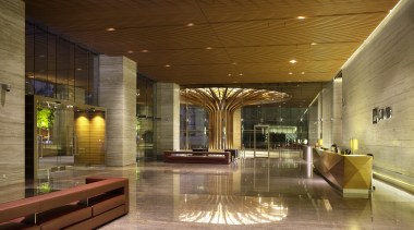 Bookmatched travertine marble walls line the lobby of architecture, ceiling, condominium, interior design, lighting, lobby, brown