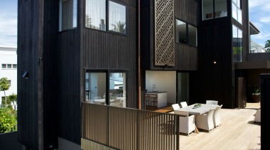 The monolithic shape of this townhouse building was apartment, architecture, building, condominium, elevation, facade, home, house, real estate, residential area, black