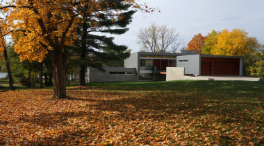 Modern riverside home with cantilevered upper level and architecture, autumn, cottage, estate, farmhouse, grass, home, house, landscape, leaf, park, plant, property, real estate, sky, sunlight, tree, brown