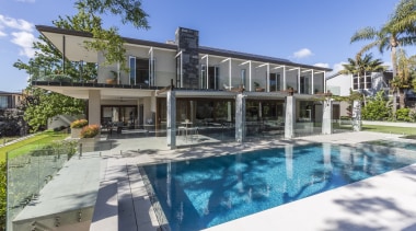 Perfect for entertaining on a grand scale, this apartment, condominium, elevation, estate, facade, home, house, property, real estate, residential area, resort, swimming pool, villa, teal