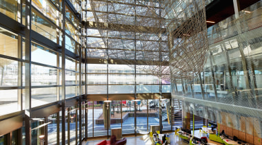 A grand atrium forms a vertical spine on architecture, building, daylighting, institution, interior design, lobby, mixed use, brown