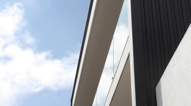 The exterior of this modern house designed by angle, architecture, building, daylighting, daytime, facade, line, product design, sky, structure, teal