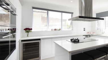 The attractive and highly functional ovens, cooktops, rangehood, cabinetry, countertop, cuisine classique, interior design, kitchen, real estate, room, white