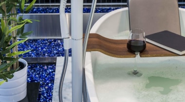 Blue glass pebbles were introduced at the base bathtub, plumbing fixture, swimming pool, water, gray, black
