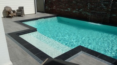 Above: This sparkling Mayfair pool in the evocative floor, leisure, property, swimming pool, water, water feature, wood, black