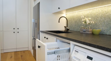 A Hideaway Laundry Hamper completes this multi-purpose space countertop, floor, interior design, kitchen, laundry room, major appliance, property, real estate, room, gray