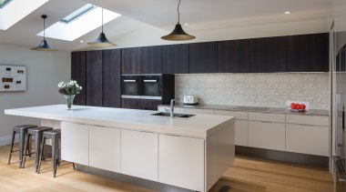 This airy kitchen by designer Pauline Stockwell offers cabinetry, countertop, cuisine classique, floor, interior design, kitchen, room, wood flooring, gray