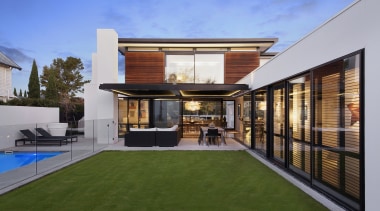 This home by designer Darren ONeil is a architecture, elevation, estate, facade, home, house, property, real estate, residential area, roof, brown