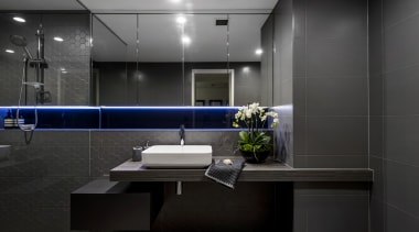 A built-out half wall concealing services and creating architecture, bathroom, glass, interior design, room, black