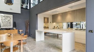 A mirror splashback and island front extends the architecture, countertop, interior design, kitchen, real estate, gray