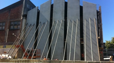 During the strengthening and restoration of Orange Hall, architecture, brutalist architecture, building, commercial building, corporate headquarters, daytime, facade, headquarters, landmark, metropolitan area, structure, gray, black