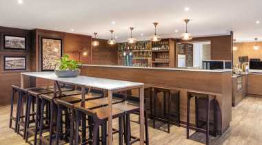 A warm, inviting bar and restaurant greets guests countertop, flooring, interior design, kitchen, real estate, table, white