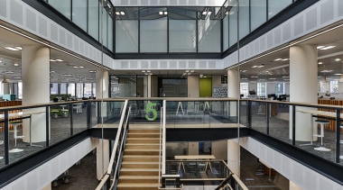 The atrium, stair, lifts and services in the apartment, architecture, building, commercial building, daylighting, interior design, lobby, metropolitan area, mixed use, shopping mall, gray, black