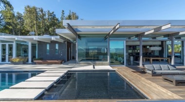 The bridge across the pool is along a estate, home, house, leisure, leisure centre, property, real estate, resort, swimming pool, villa, teal