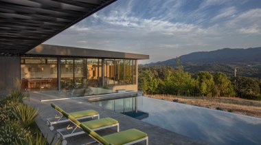 Sitting at the top of a ridge, this architecture, daylighting, estate, home, house, property, real estate, reflection, roof, sky, swimming pool, villa, gray, black