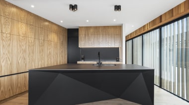 Matt black and faceted, the island would be 
