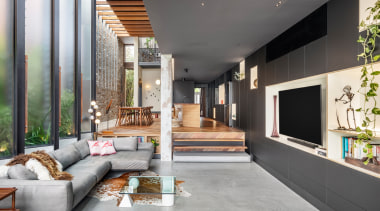 The living room with soaring, light-bringing operable louvre 