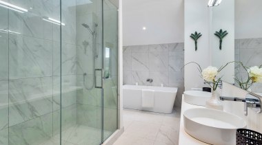 The modern master bathroom features table top basins, 