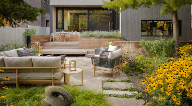This multi-level dining/​entertaining zone features an ipe wood 