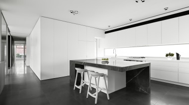 Positioned between the two living areas, the kitchen architecture, black and white, countertop, floor, house, interior design, kitchen, real estate, white, black