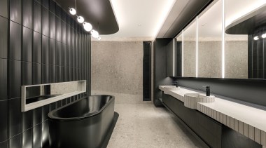 The bathings space's crenulated wall finish is echoed 