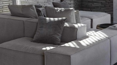 Earthy external cladding materials are continued inside. 