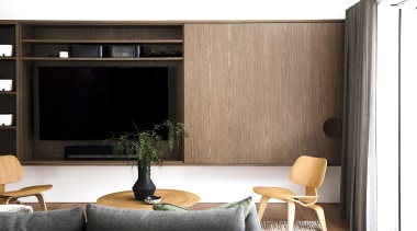 Bespoke walnut cabinetry offers handy living space functionality 