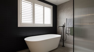 The designer used a dark textured tile on 