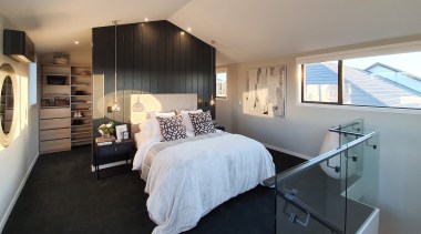 A floor-to-ceiling bedhead separates bedroom from dressing area. 