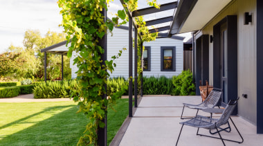 Lush landscaping envelopes cottage and house. Design: Nadia 