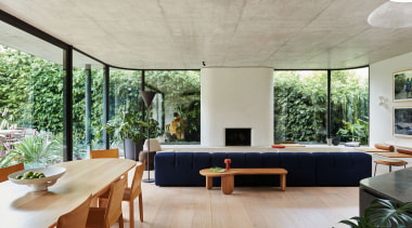 A wood dining table complements the floor finish 