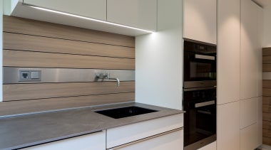 Understated satin lacquer cabinetry helps to blend this architecture, building, cabinetry, ceiling, countertop, cupboard, drawer, floor, furniture, home, home appliance, house, interior design, kitchen, material property, plywood, property, real estate, room, gray