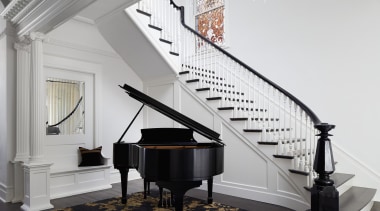 Grand piano meets grand staircase in the entry 