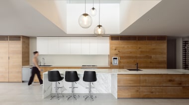 Anchored by the extended Calacatta marble island bench, 