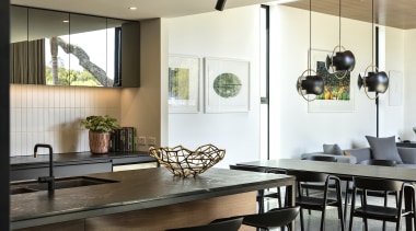The kitchen benches are a leathered black granite, 