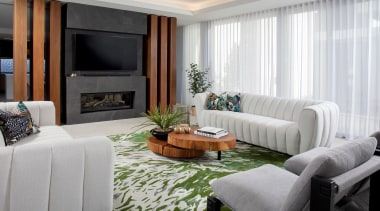 Living room backdropped by soft curtaining. 
