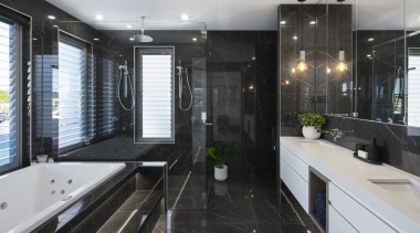 The dark, moody tones of this elegant ensuite apartment, architecture, bathroom, building, cabinetry, ceiling, countertop, floor, flooring, furniture, glass, home, house, interior design, plumbing fixture, property, real estate, room, sink, tile, black, gray