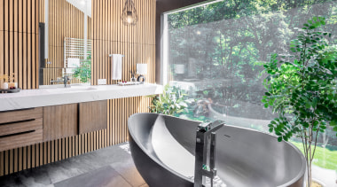 The sculptural, dark toned freestanding tub for two 