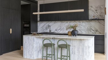 The dark, minimalist joinery lets the noble stonework 
